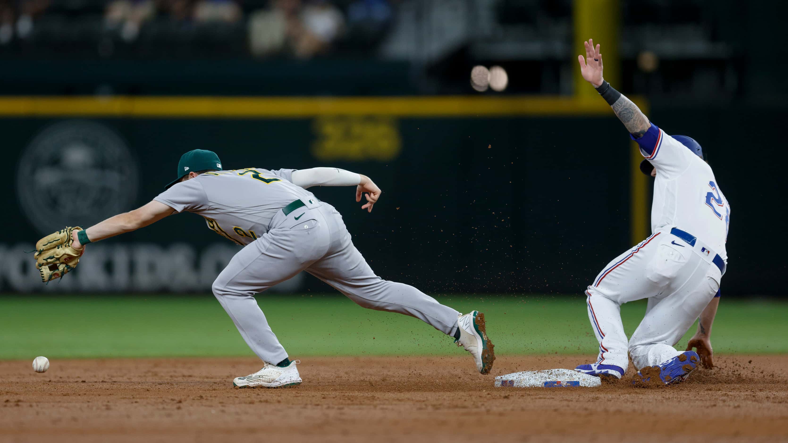 Texas Rangers catcher Jonah Heim (28) slides safely into second base as Oakland Athletics...