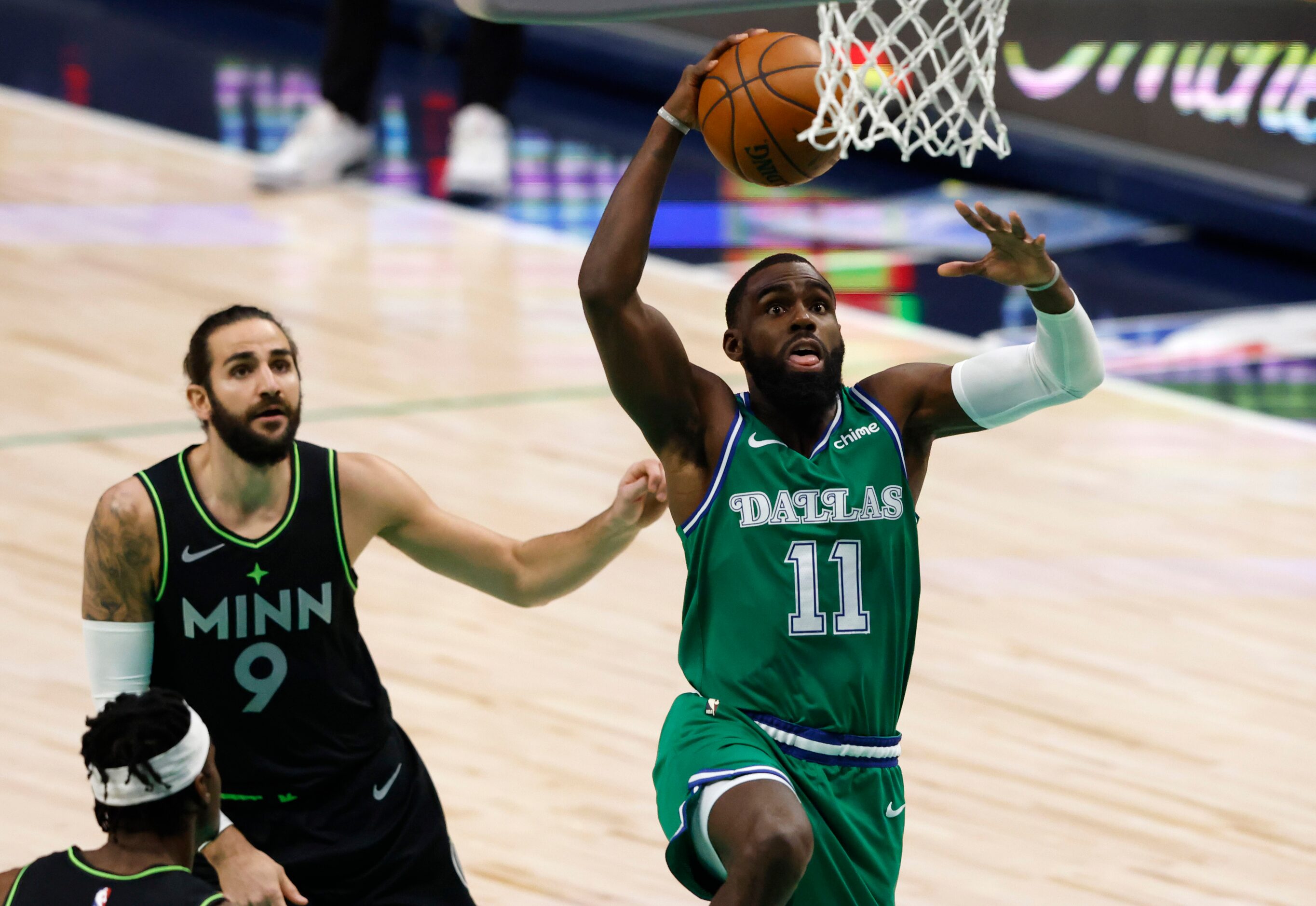 Dallas Mavericks guard Tim Hardaway Jr. (11) dunks the ball in front of Minnesota...