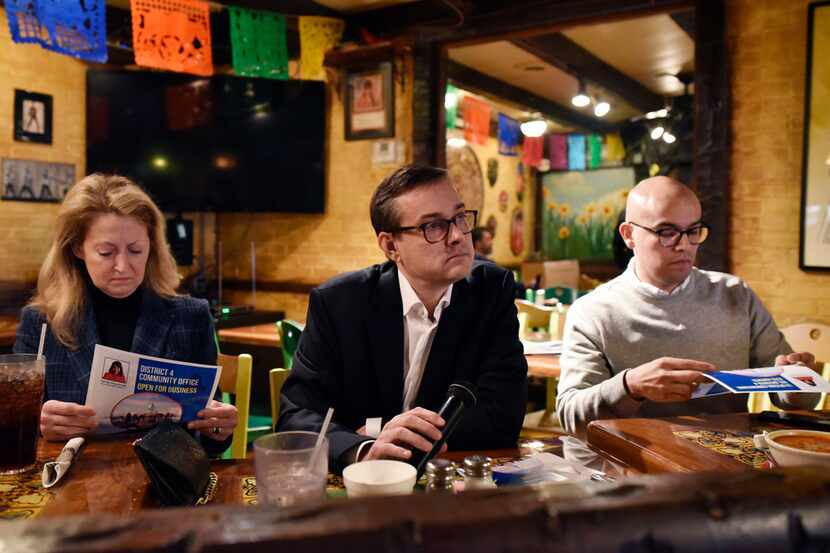 Dallas mayoral candidate Scott Griggs (center) listened to a question at the monthly...