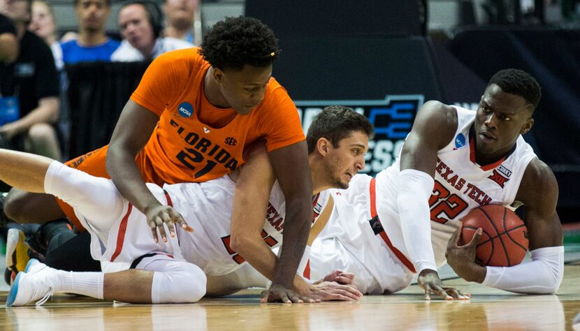 Texas Tech Red Raiders center Norense Odiase (32) and guard Davide Moretti (25) reach for a...