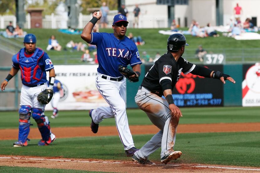 Texas Rangers third baseman Adrian Beltre, center, chases Chicago White Sox's Jacob May,...