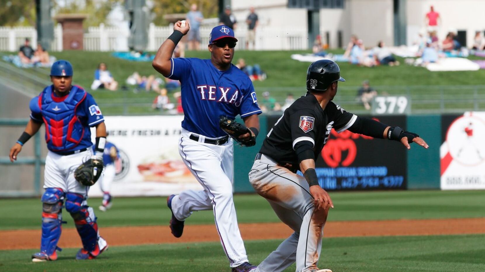 Texas Rangers third baseman Adrian Beltre, center, chases Chicago White Sox's Jacob May,...