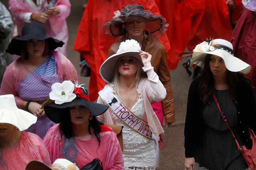 Women wear hats before the 144th running of the Kentucky Derby horse race at Churchill Downs...