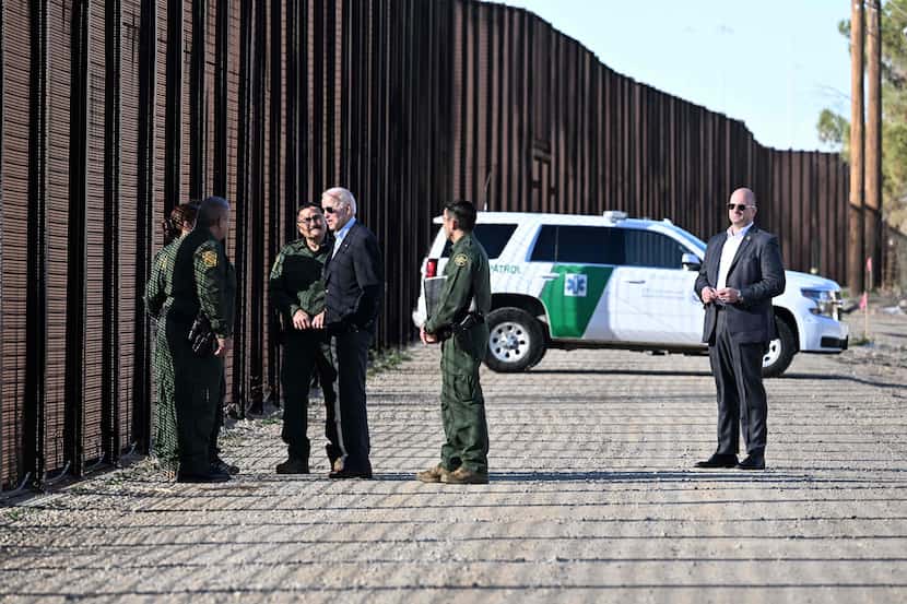 President Joe Biden speaks with members of the Border Patrol at the US-Mexico border fence...