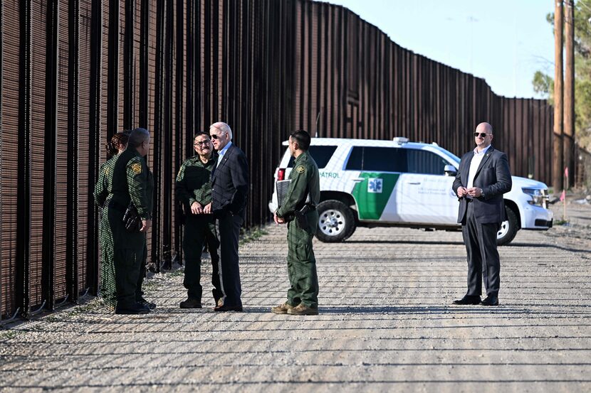 President Joe Biden speaks with members of the Border Patrol at the US-Mexico border fence...