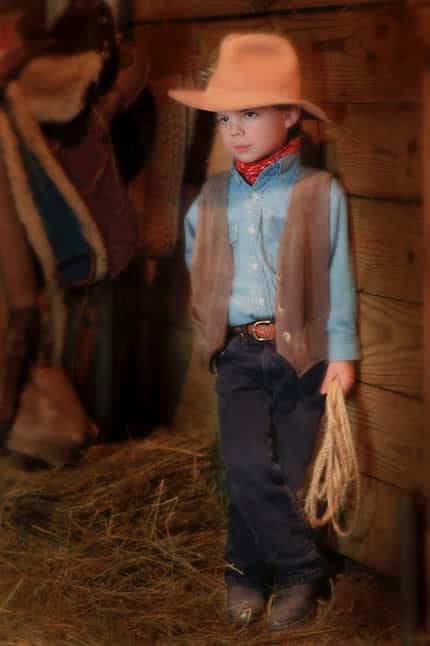 A 5-year-old Charles Scudder poses for a portrait at a horse ranch in Cincinnati, Ohio....