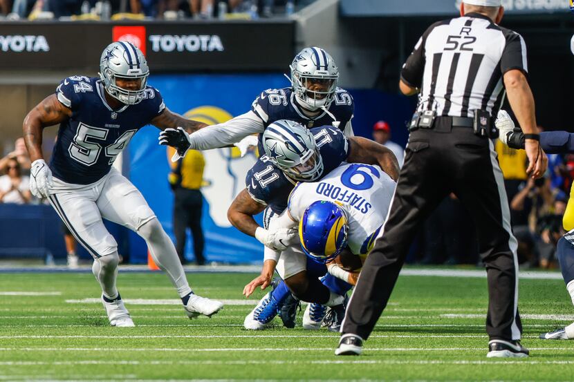 Los Angeles Rams quarterback Matthew Stafford (9) gets sacked by Dallas Cowboys linebacker...