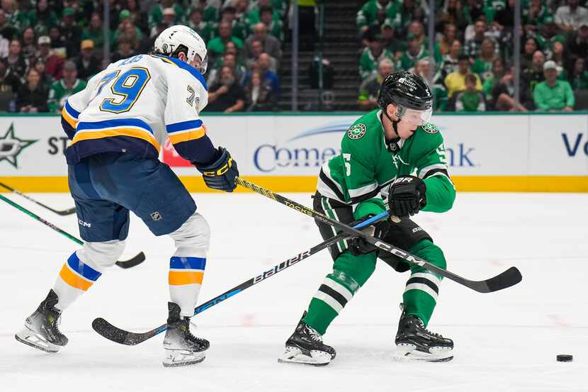 Dallas Stars defenseman Nils Lundkvist (5) takes the puck away from St. Louis Blues left...