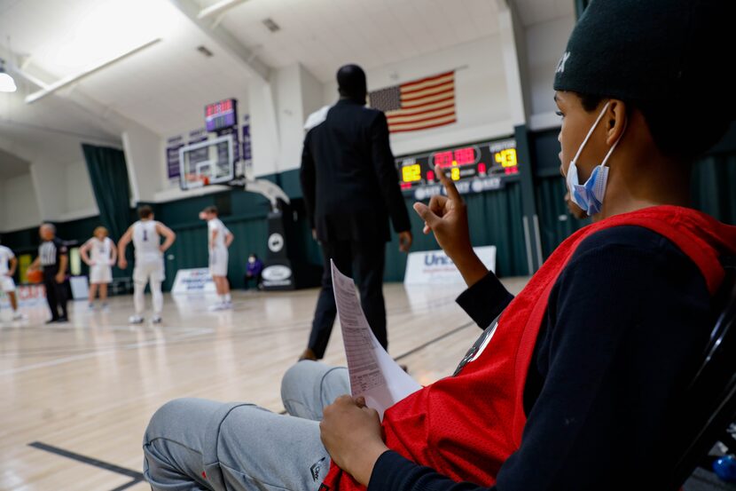 Dallas Christian College's assistant coach Bobby Kirby's son Josiah Coleman (right) takes...