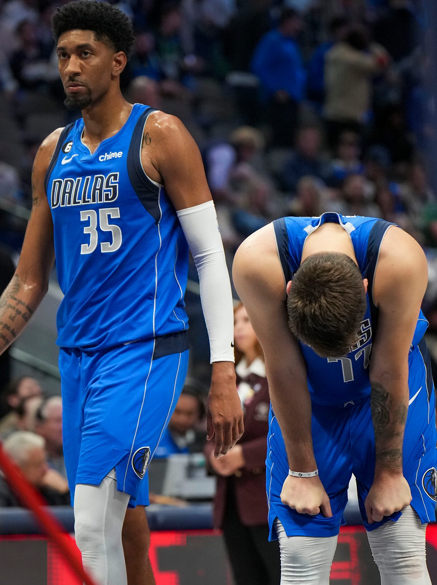 Dallas Mavericks guard Luka Doncic (77) and center Christian Wood (35) react after a timeout...