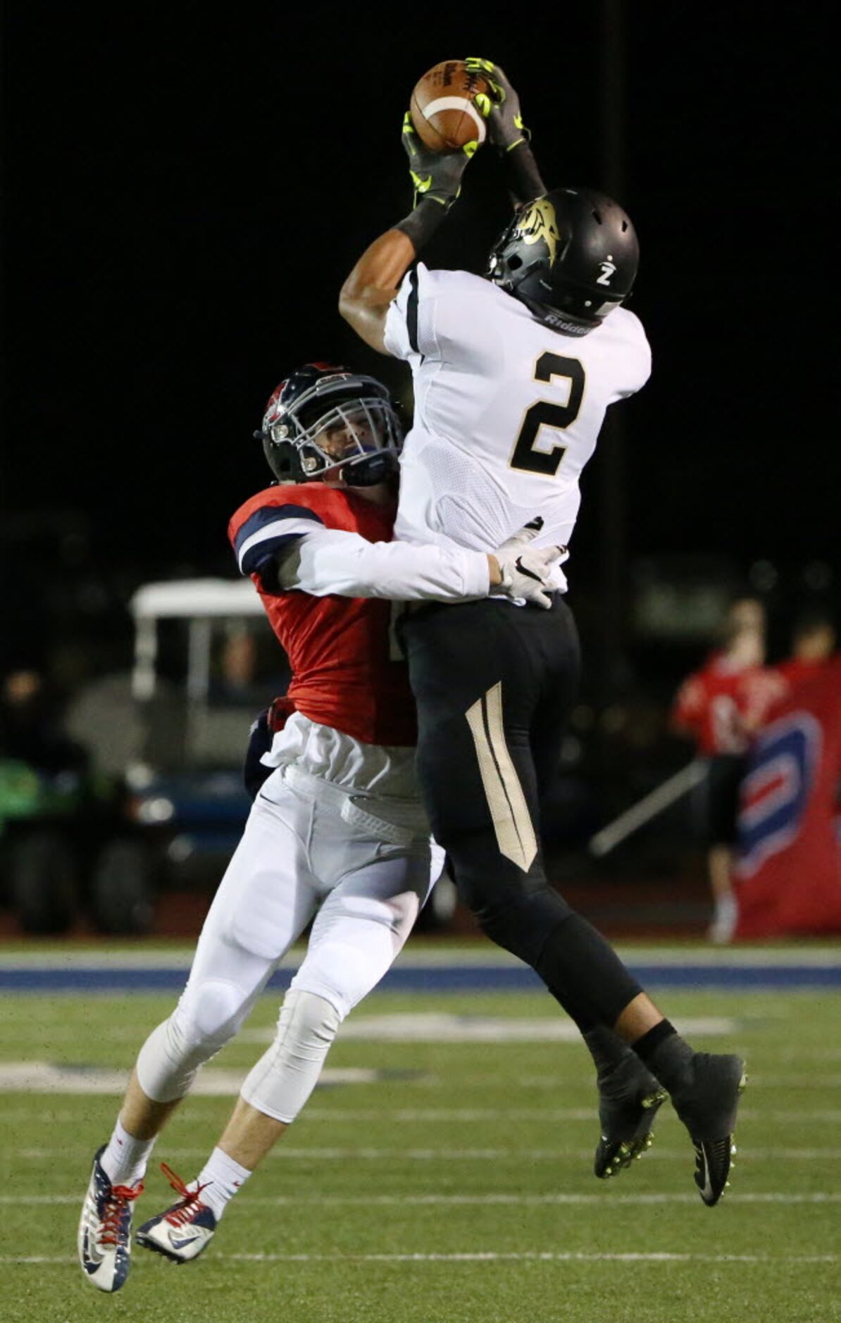 Plano East wide receiver Tim Wilson (2) catches the ball over McKinney Boyd defensive back...