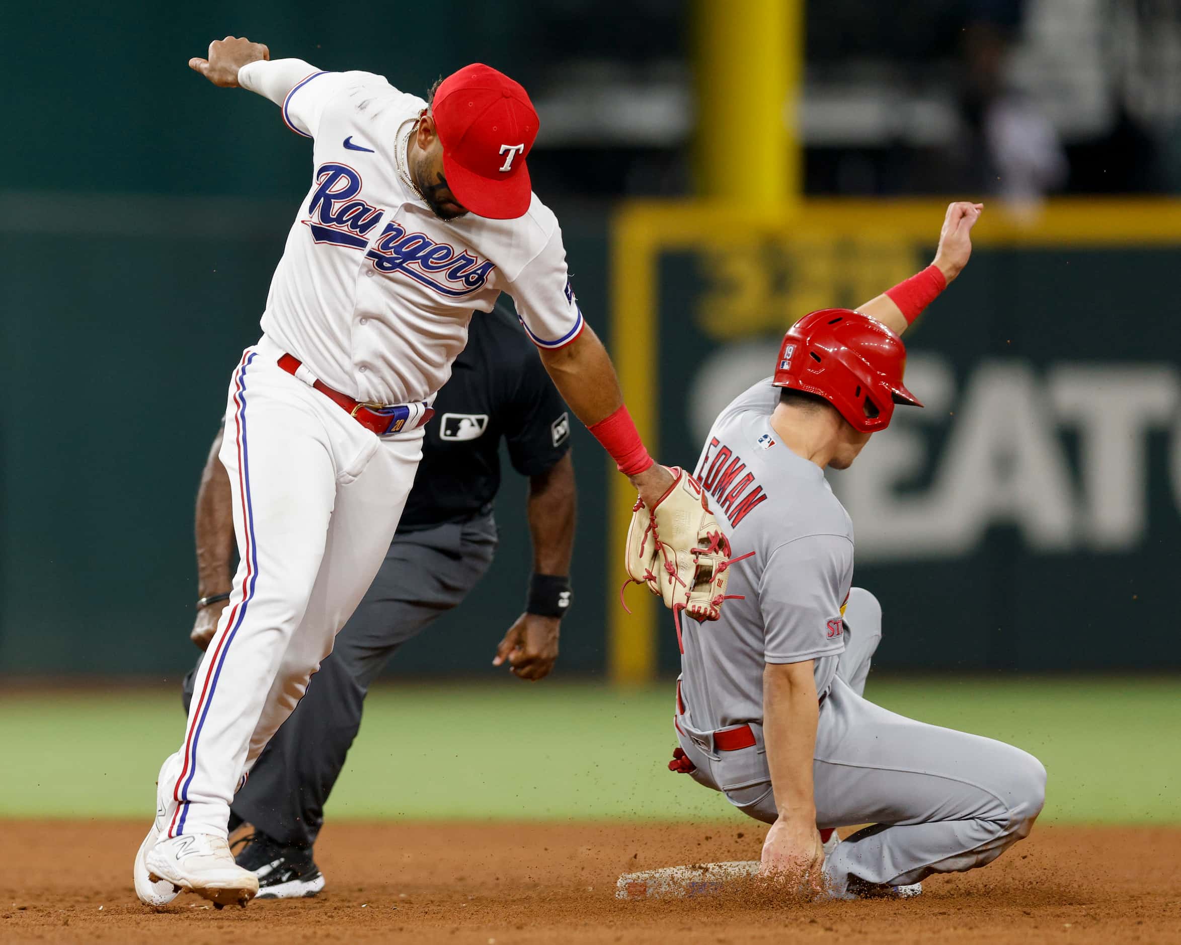 St. Louis Cardinals center fielder Tommy Edman (19) steals second base ahead of a tag from...
