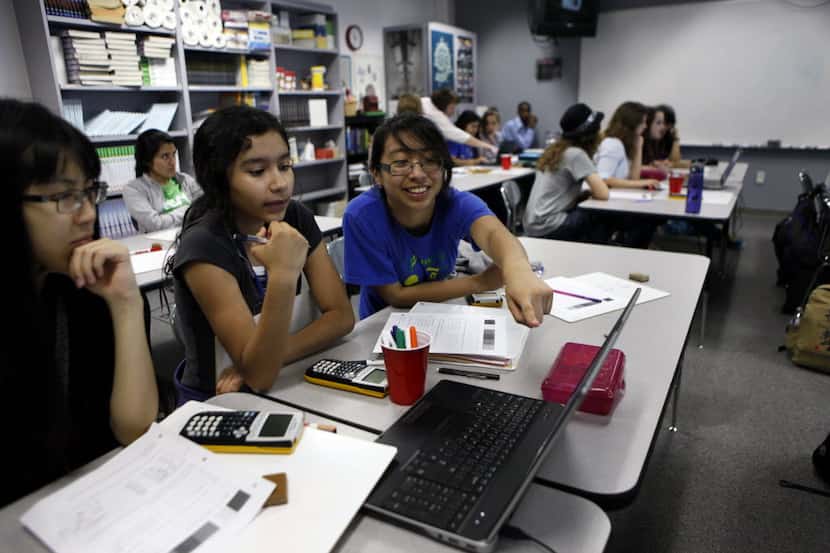  Freshman Raquel Hernandez, 15, left, and Daisy Ariza, 15, right, work on an assignment...