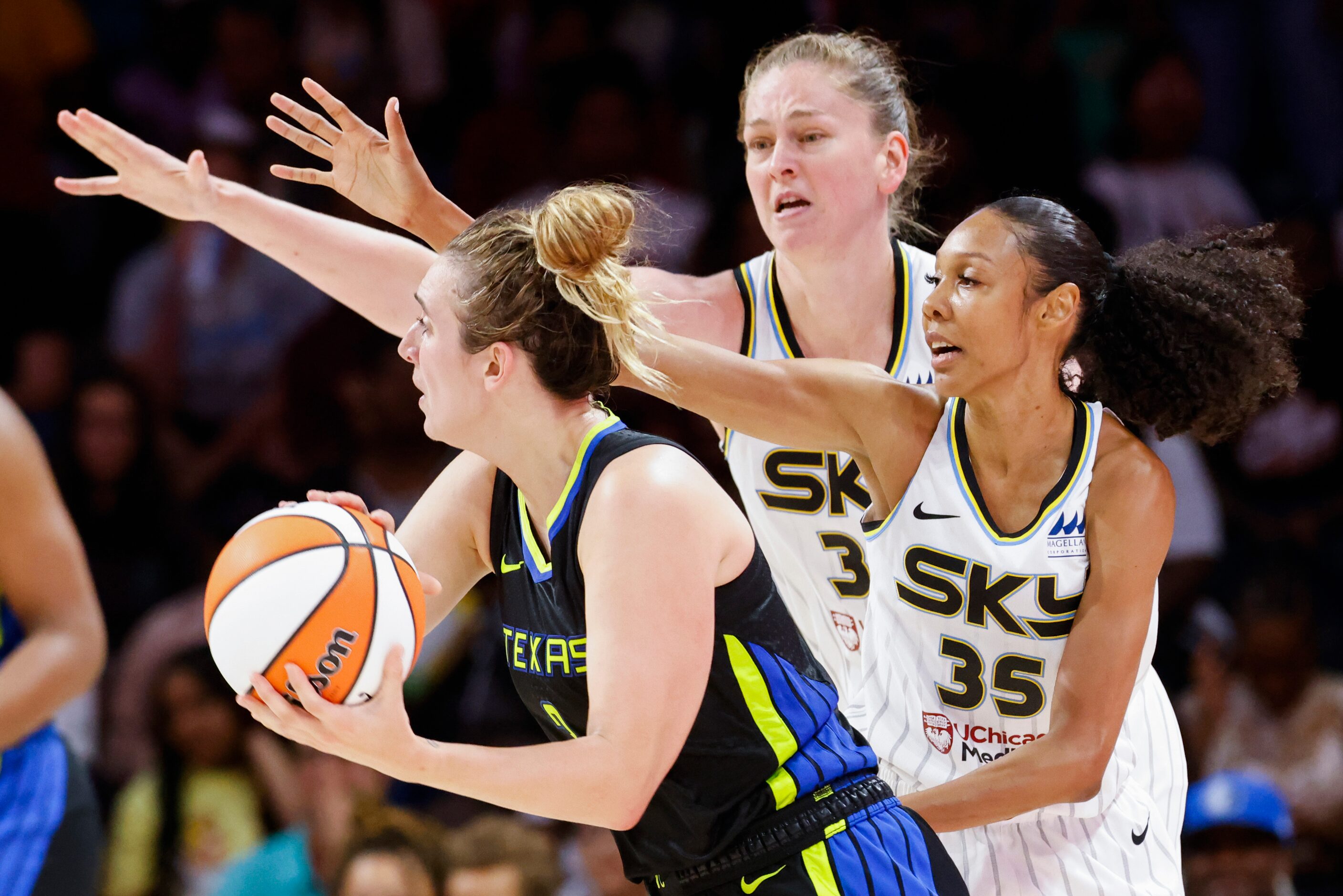 Dallas Wings guard Marina Mabrey, left, looks to pass as Chicago Sky guard Rebekah Gardner,...