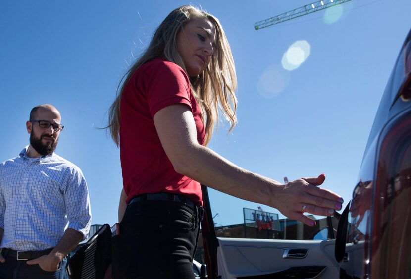 Toyota product specialist Carly White, right, shows Art Reinhardt, City of San Antonio's...