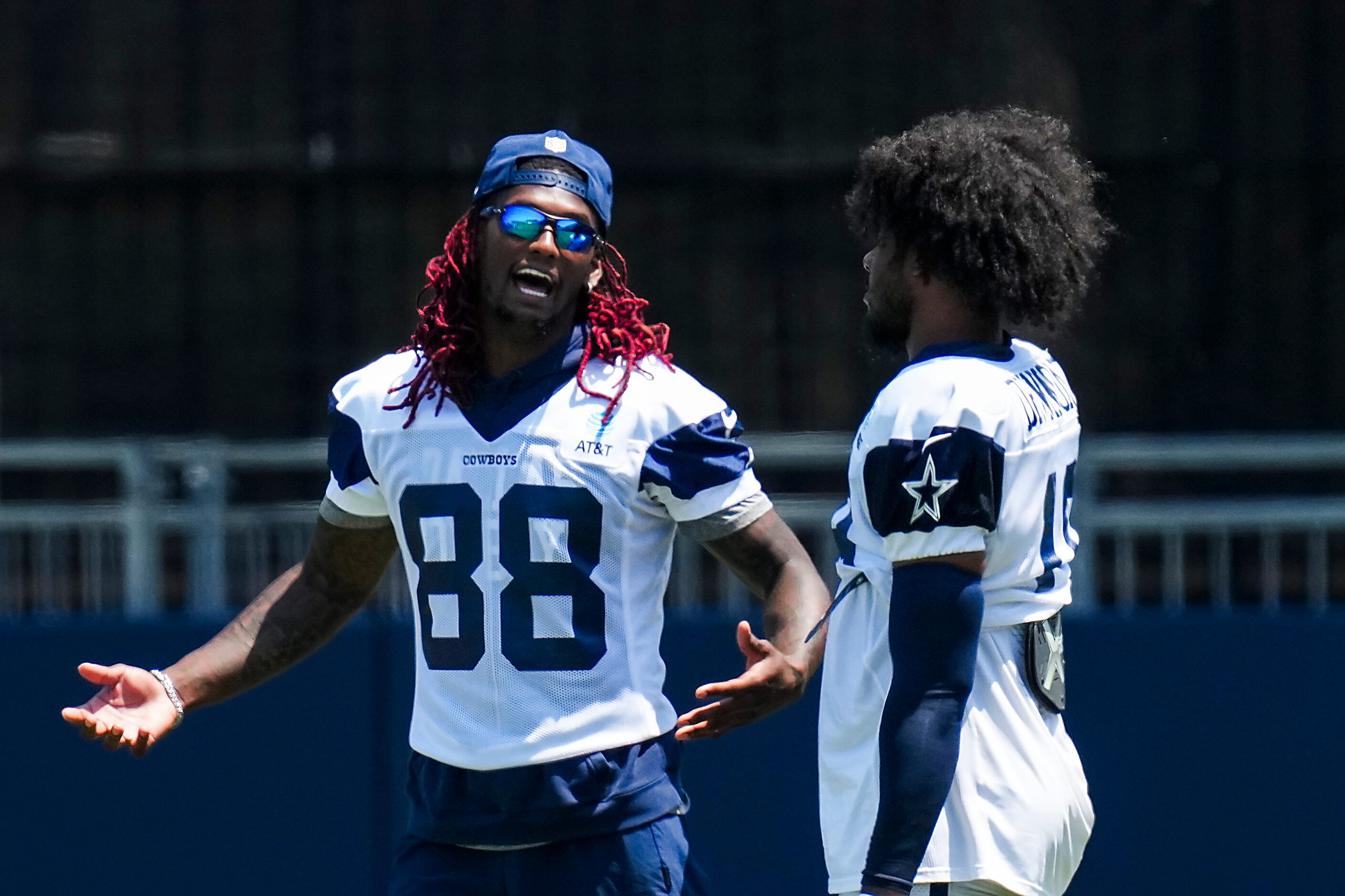 Dallas Cowboys wide receiver CeeDee Lamb (88) talks with wide receiver Dontario Drummond...