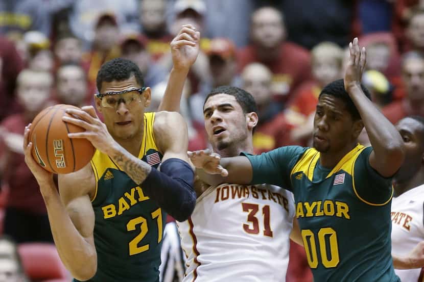 Iowa State forward Georges Niang, center, fights for a rebound with Baylor's Isaiah Austin,...