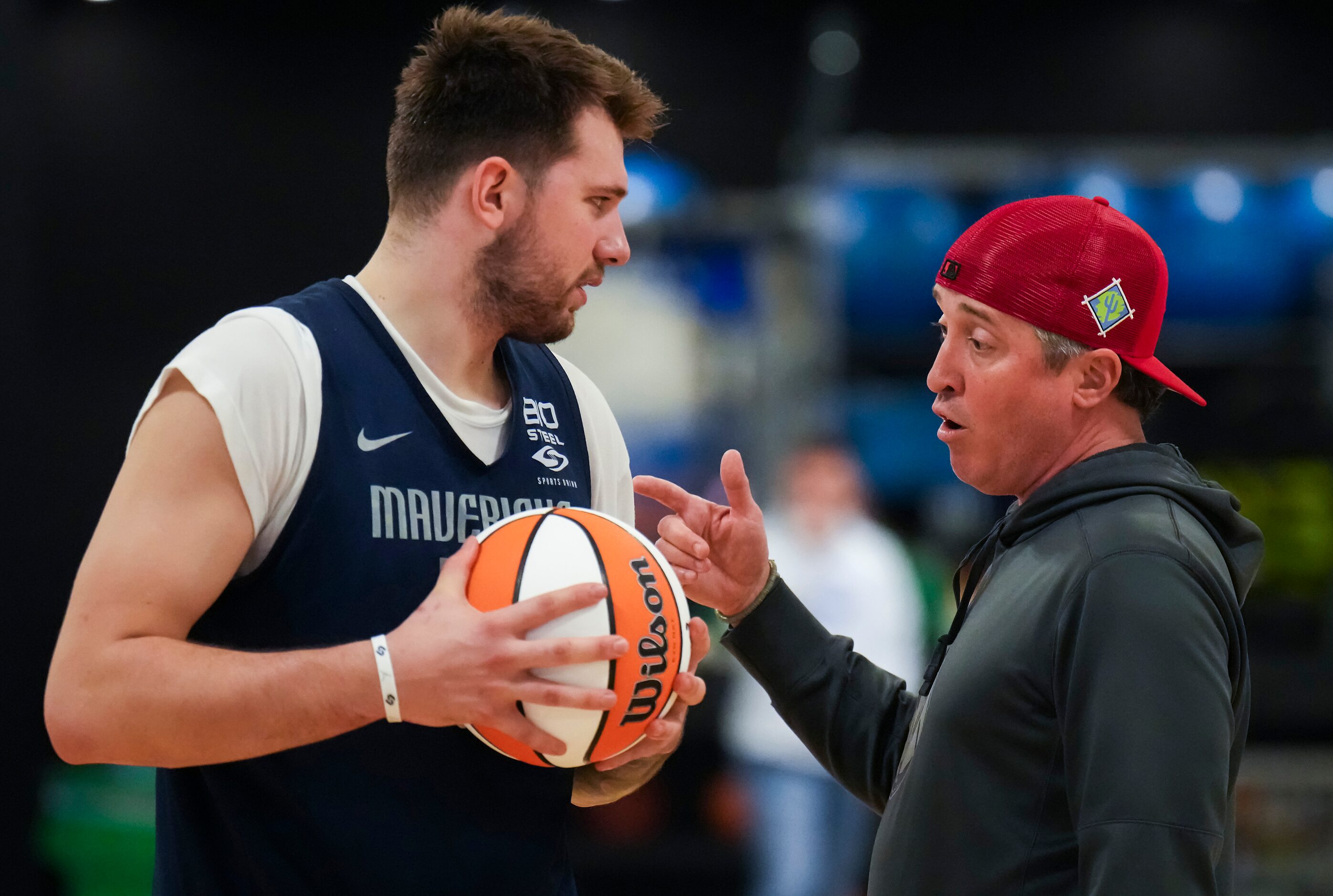 Dallas Mavericks guard Luka Doncic talks with Casey Smith, director of player health and...