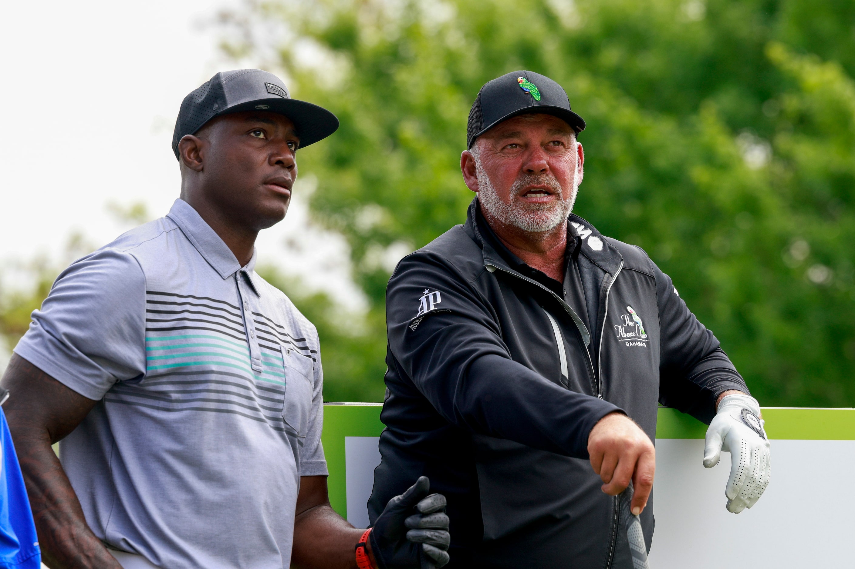 Former Dallas Cowboys player DeMarcus Ware (left) speaks with professional golfer Darren...