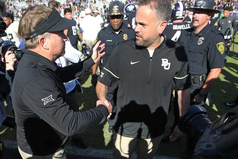 TCU head coach Gary Patterson shakes hands with Baylor head coach Matt Rhule after the...