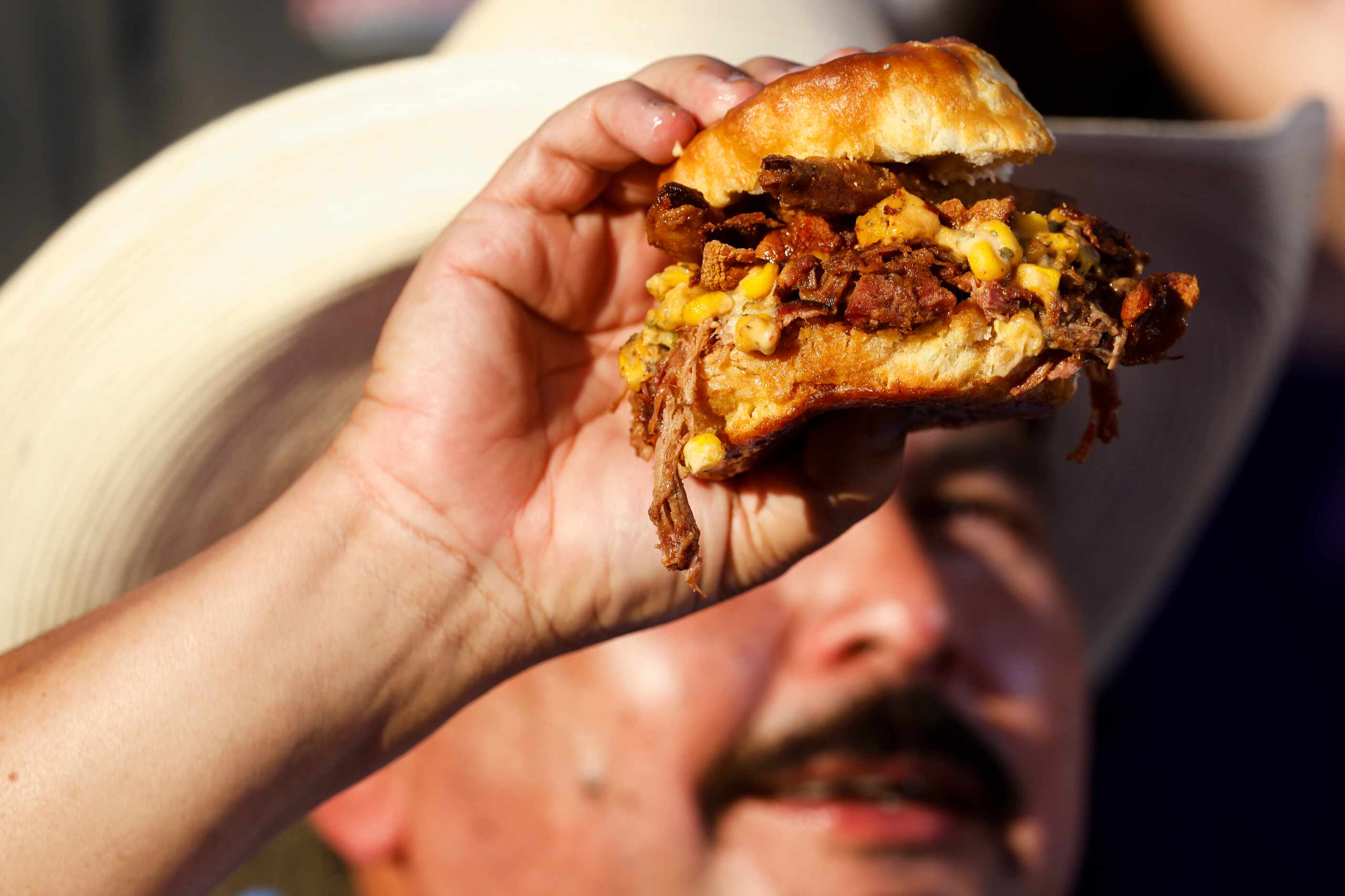 Guillermo Rodriguez shows the Holy Biscuit, one of the Big Tex Choice Award finalists,...