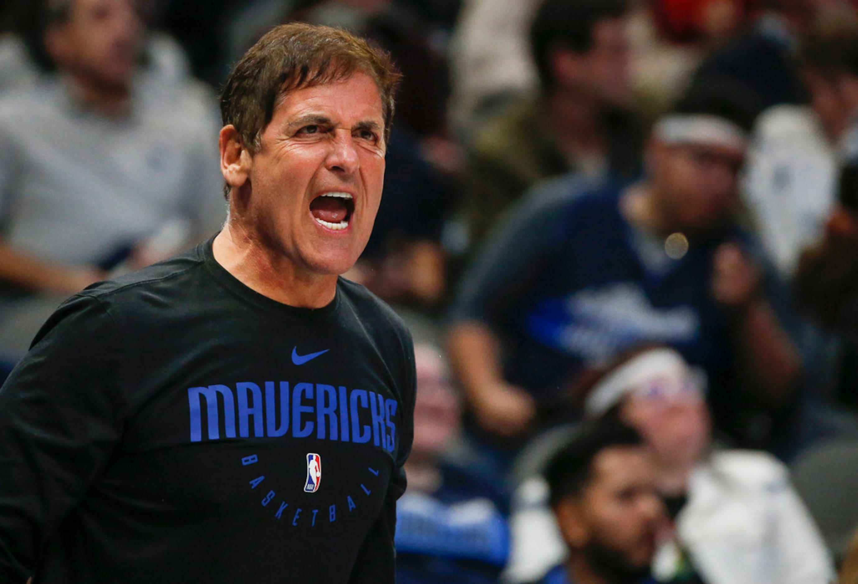 Dallas Mavericks owner Mark Cuban yells to a game official during overtime in a NBA...