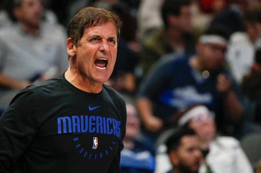 Dallas Mavericks owner Mark Cuban yells to a game official during overtime in a NBA...