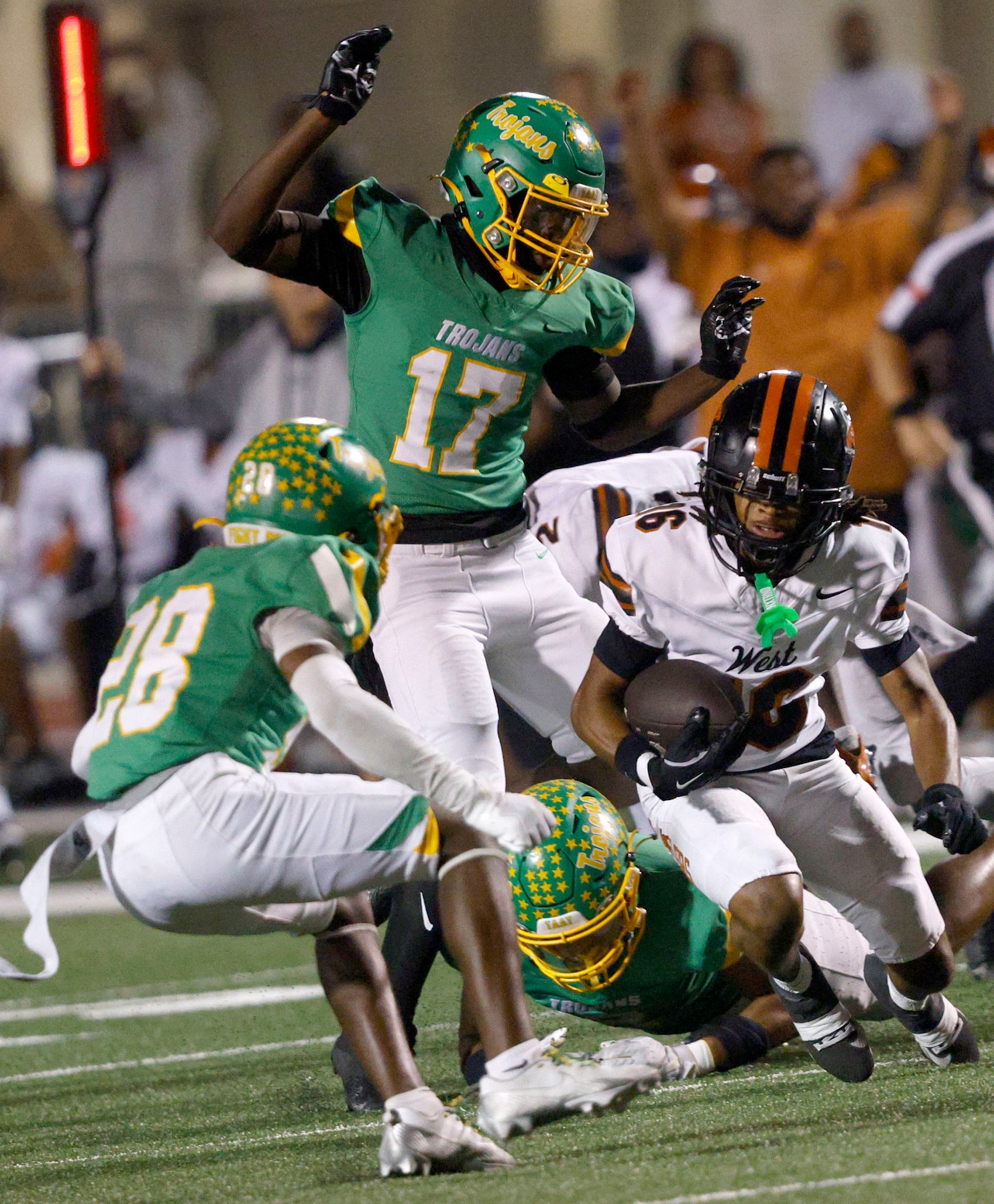 West Mesquite's Darieon Parker (16) carries the ball as Newman Smith's Sian Edwards (17),...