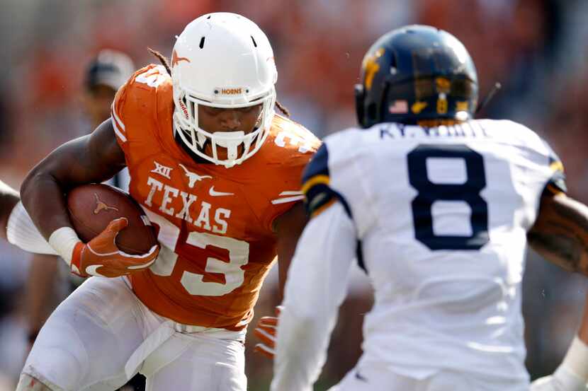 Texas running back D'Onta Foreman runs against West Virginia's Kyzir White in the second...