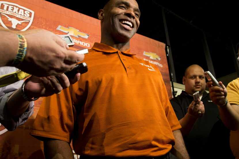 Texas football coach Charlie Strong talks with reporters at the Texas Sports Hall of Fame,...