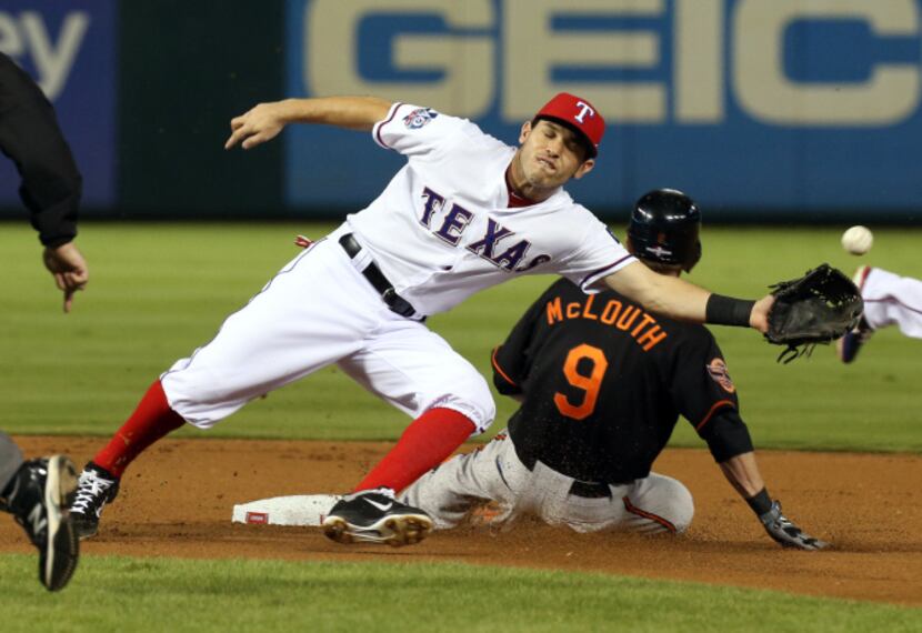 Baltimore Orioles left fielder Nate McLouth (9) steals 2nd in the first inning in front of...