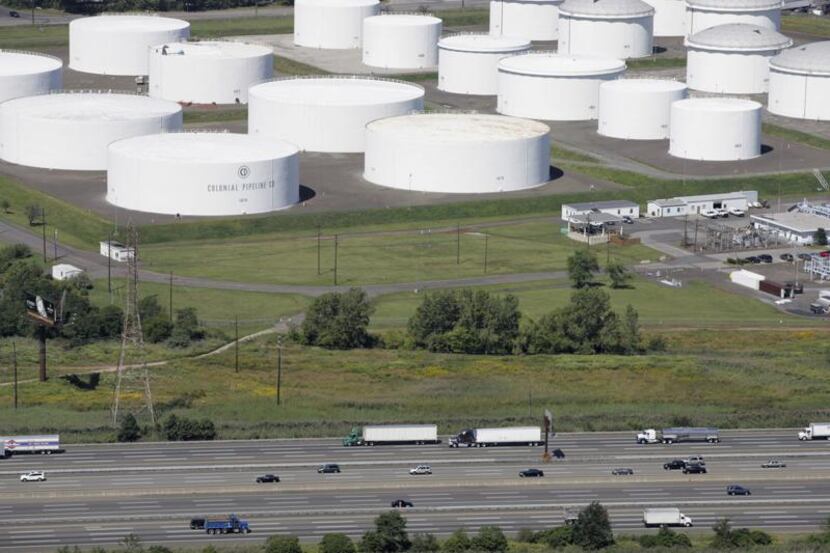 FILE - In this Sept. 8, 2008 file photo traffic on I-95 passes oil storage tanks owned by...