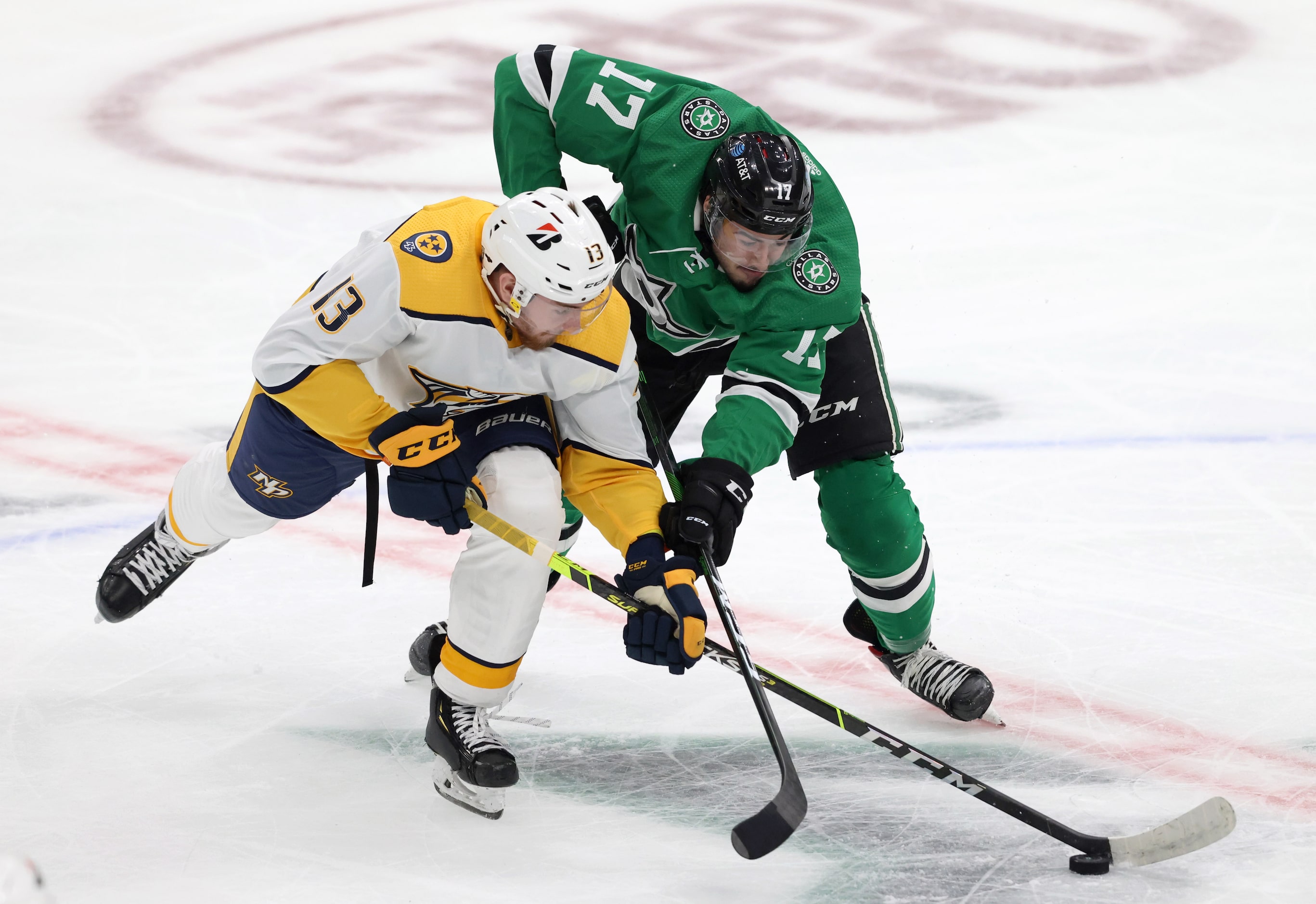 Dallas Stars Nicholas Caamano (17) and Nashville Predators center Yakov Trenin (13) fight...