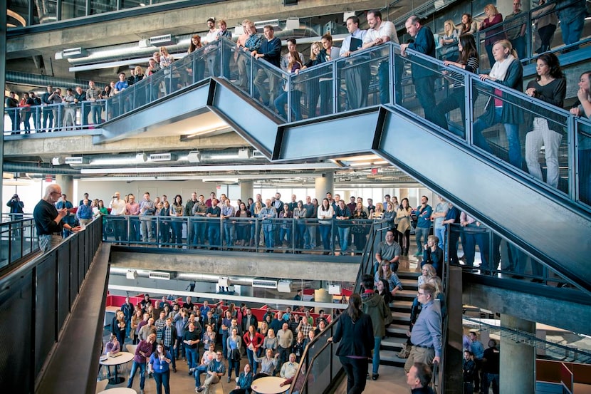 
Richards Group  employees gathered at the three-story atrium staircase in the ad agency’s...