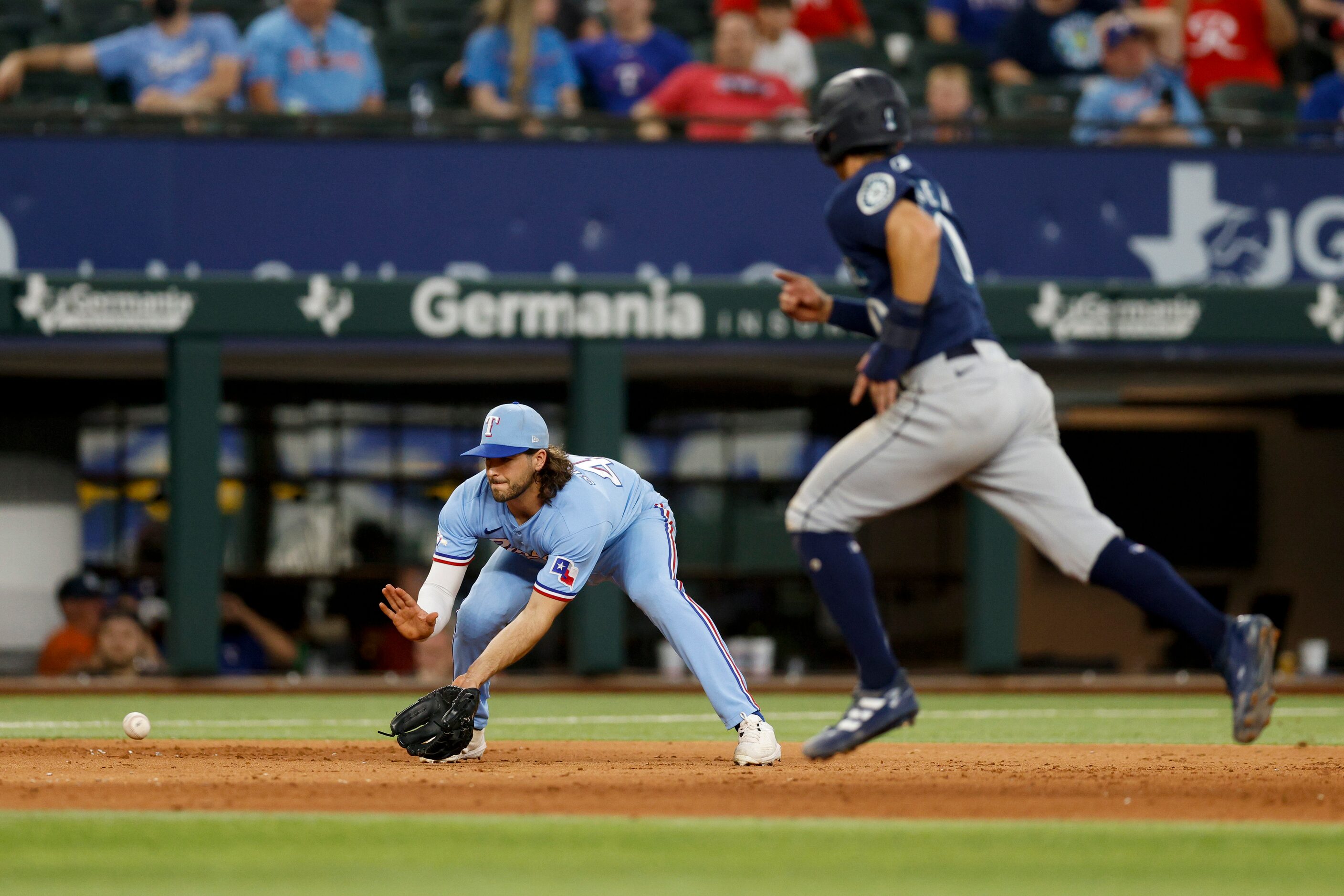 Texas Rangers third baseman Josh Smith (47) fields a ball during the ninth inning of a game...