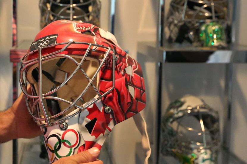 Former Dallas Stars goalie Marty Turco shows the mask he wore in the 2006 Olympics, at his...