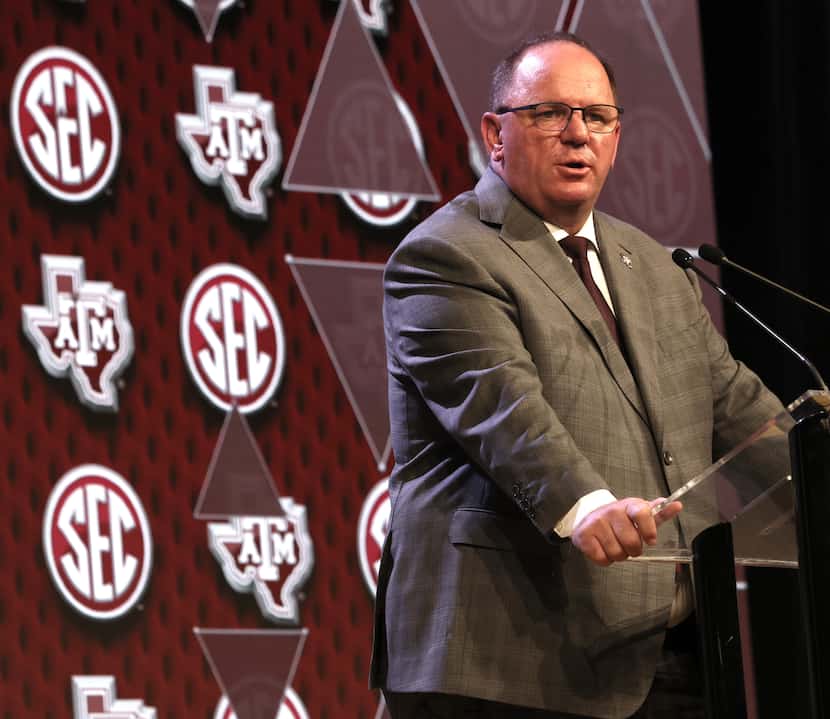 Texas A&M head football coach Mike Elko answers a question from a media member during the...