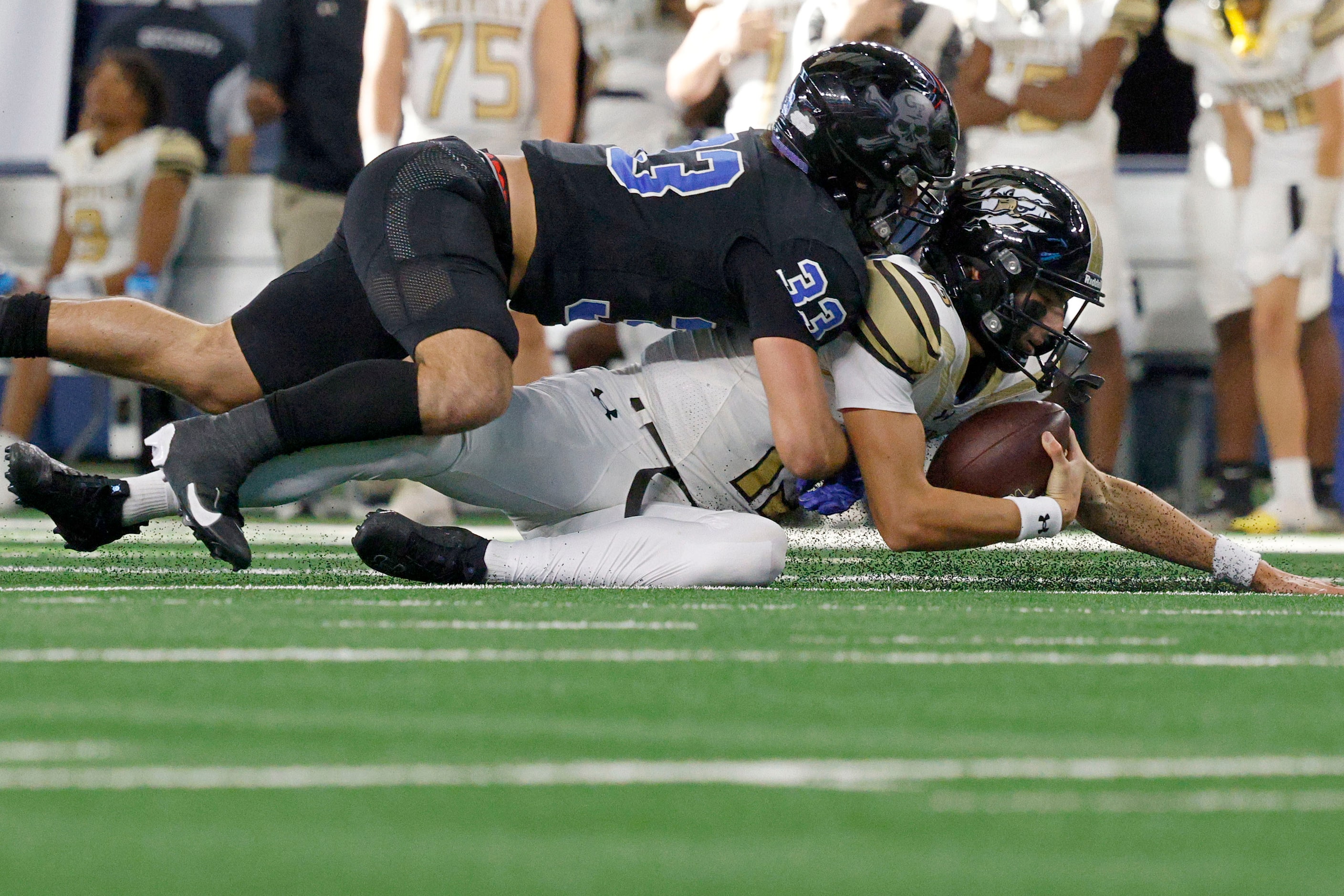 Woodville's quarterback Luke Babin (13) is sacked by Gunter's  Hayden Farrell (33) in the...