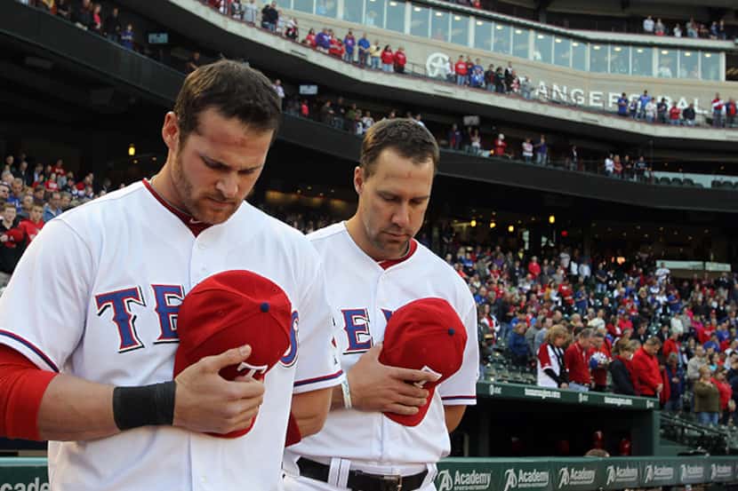  April 19, 2013--Texas outfielders Craig Gentry and David Murphy observe a moment of silence...