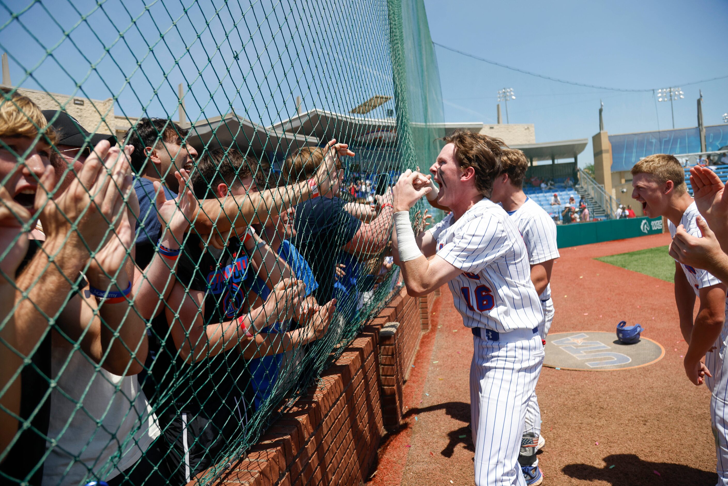 Trinity Christian’s Lleyton Myers (16) runs to greet fans after defeating Houston St....