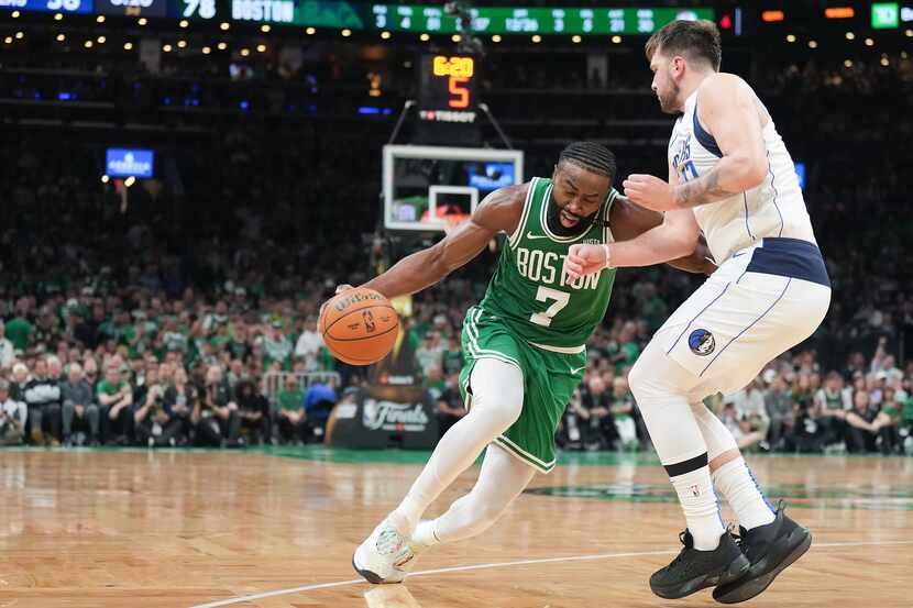 Boston Celtics guard Jaylen Brown (7) drives on Dallas Mavericks guard Luka Doncic (77)...