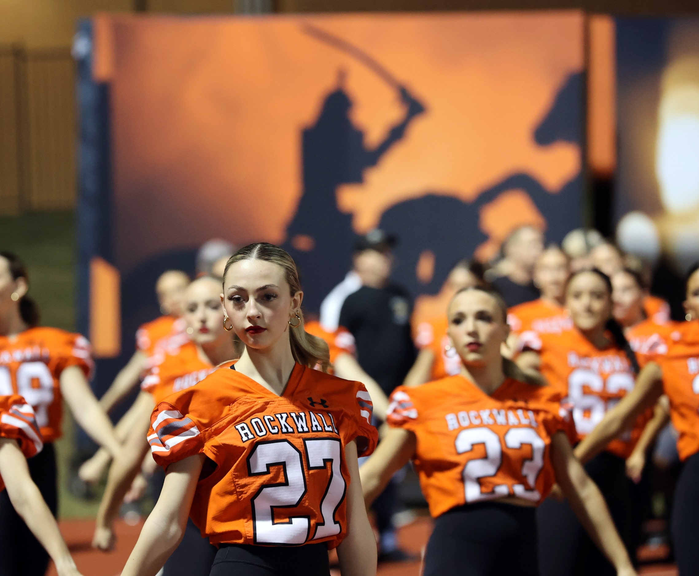 Rockwall High dancers practice in front of a band banner during the first half of a high...