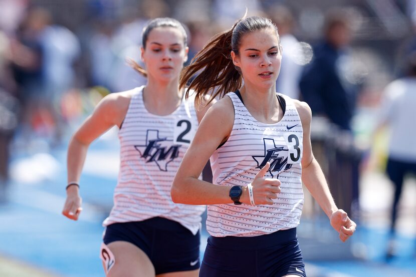 Flower Mound’s Samantha Humphries leads her sister Nicole Humphries in the girls 800 meter...