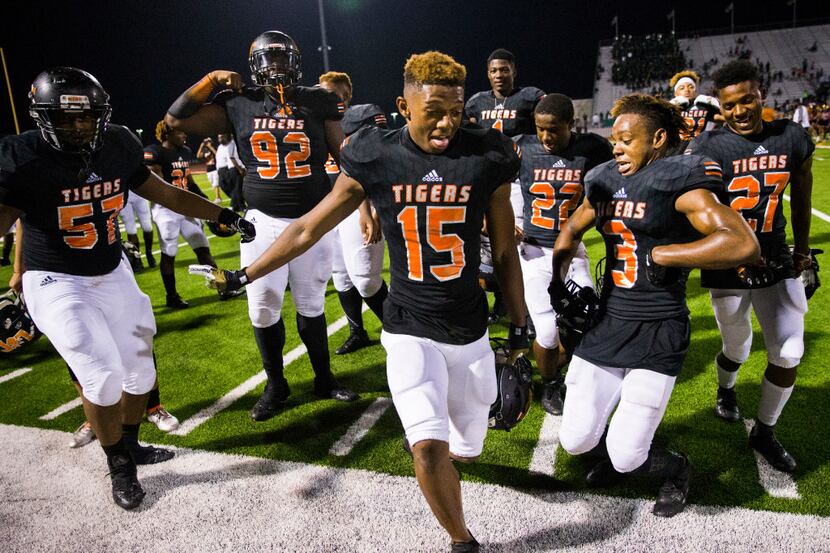 Lancaster football players dance as they celebrate a 54-38 win over Mansfield Lake Ridge on...