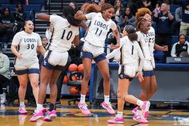 Little Elm's Keivia Scott (11) with Amina Diallo (10) at the final buzzer of a victory over...