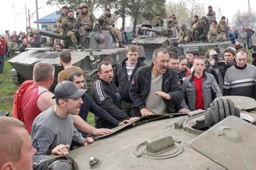 
Pro-Russian activists blocked Ukrainian men riding on armored personnel carriers in...