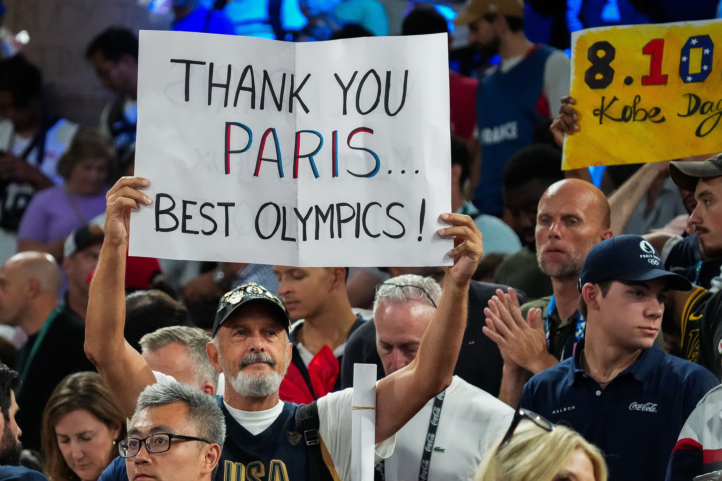 Fans cheer after a victory by the United States over France in the men's gold medal...