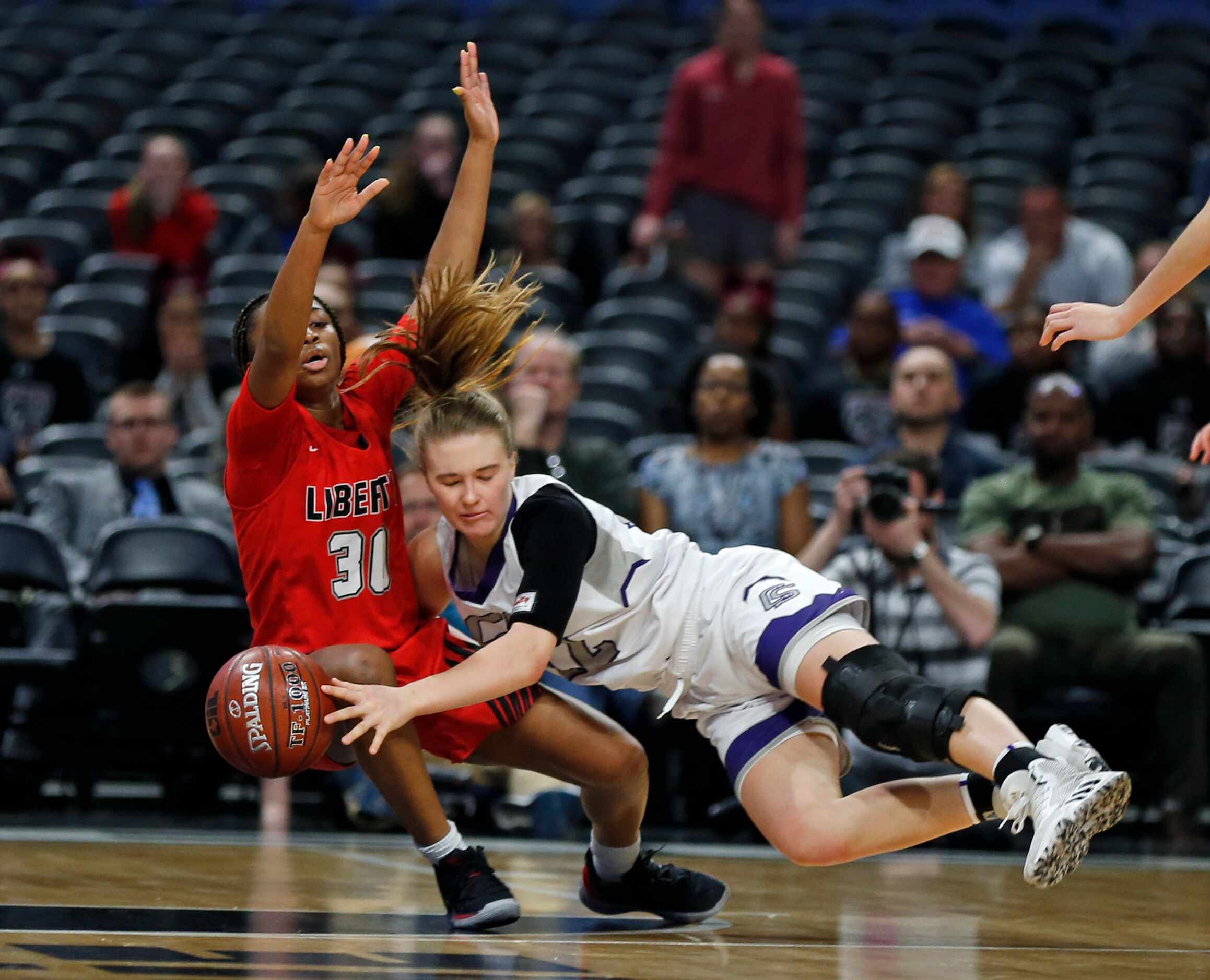 Frisco Liberty Jazzy Owens-Barnett #30 forces a turnover on College Station guard Rebekah...