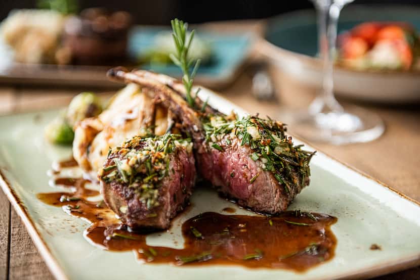 Cru Food and Wine Bar in Dallas is serving rosemary crusted rack of lamb as part of its...