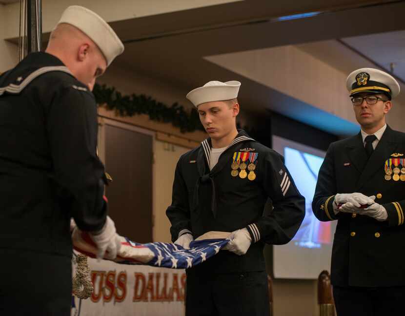 Sailors assigned to Los Angeles-class fast-attack submarine USS Dallas (SSN 700), fold the...